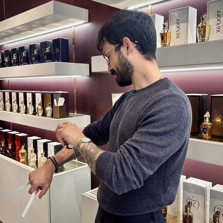 Joe, founder of ElixirDiUomo, trying a fragrance in a perfume store